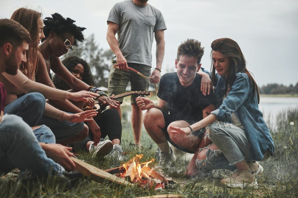 Group of people have picnic on the beach. Friends have fun at weekend time